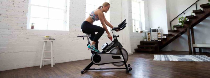 woman using home spin bike
